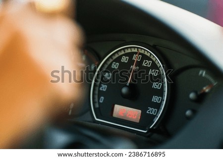 Close up of car speed meter showing 100km per hour driving at night Royalty-Free Stock Photo #2386716895