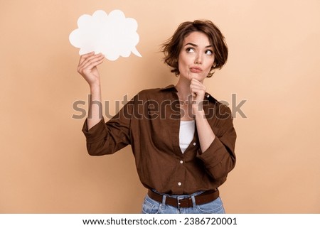 Photo of doubtful unsure lady wear brown shirt looking speaking bubble empty space isolated beige color background