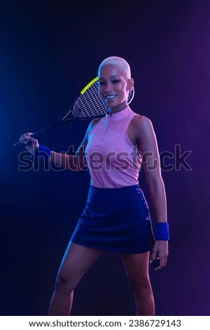 Squash player on a squash court with racket. White sportswear. Beautiful girl teenager and athlete with racket on court. Sport concept.
