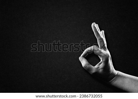 Hand Showing OK Good Sign in Black and White on Textured Paper Background, Copy Space