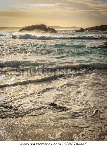 Stormy beach scene with high tide and islands in the background. Esperance Western Australia.
