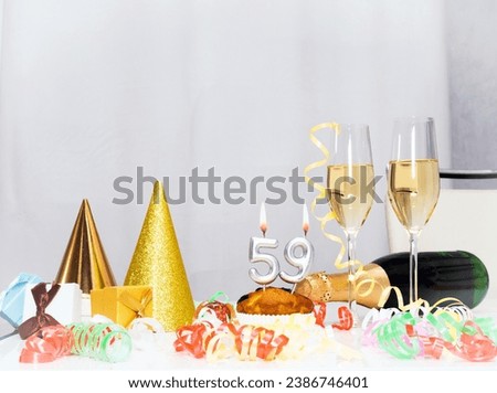 Date of Birth  59. Festive background with a bottle of champagne. Festive Champagne in glasses with gift boxes, anniversary card, happy birthday decorations in white colors