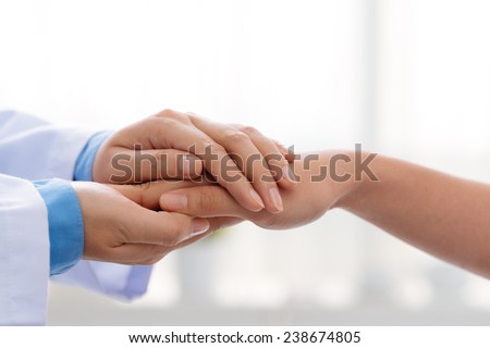 Hand of doctor reassuring her female patient Royalty-Free Stock Photo #238674805