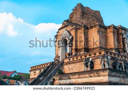 Main central,14th Century chedi of the extensive temple complex, ancient Lanna architecture,lit by late afternoon sun,beautiful area surrounded by trees,within the Old City perimeters of Chiangmai. Royalty-Free Stock Photo #2386749921