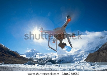 White flying drone taking picture of landscape in Tibet, China