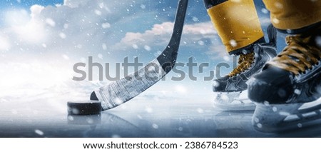 Hockey puck and stick close-up. Hockey player in ice rink. Focus on the puck. Hockey concept. Ice. Outdoor skating rink Royalty-Free Stock Photo #2386784523