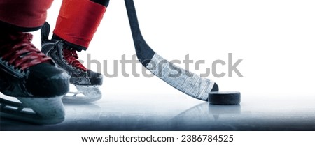 Hockey puck and stick close-up. Hockey player in ice rink. Focus on the puck. Hockey concept. Ice. Isolated