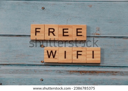 wood tile with word FREE WIFI on blue wooden texture