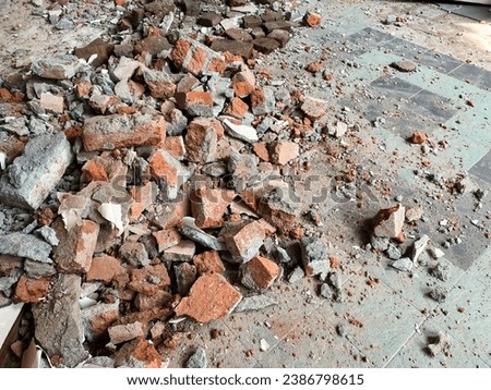Pile of rubbish red bricks from demolished wall in renovated house Royalty-Free Stock Photo #2386798615