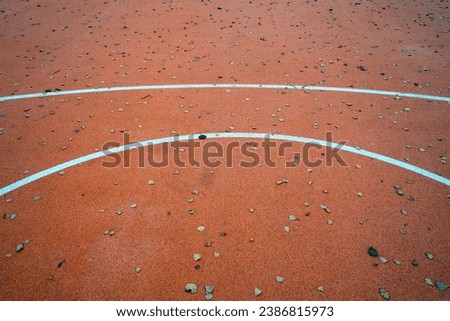 Basketball court in autumn with fallen leaves on it. Seasonal sport background.        