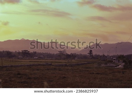 sunset view with layers of mountains in a photo with low exposure and high noise