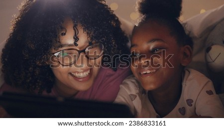 Mom, daughter and tablet at night with internet for movie, cartoon or streaming with blanket on bed in bedroom. Family, woman and girl child with technology in the dark for film, video and bonding