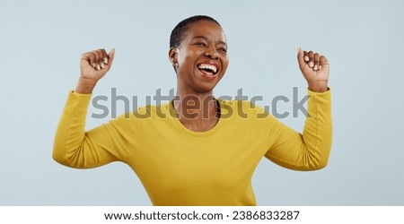 Excited black woman, dancing and celebration for winning or promotion against a gray studio background. Face of happy African female person or model in joy or satisfaction for bonus or good news