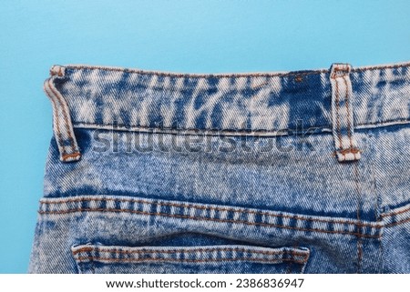 blue denim jeans with prominent stitching. Close up of jeans with lots of pockets