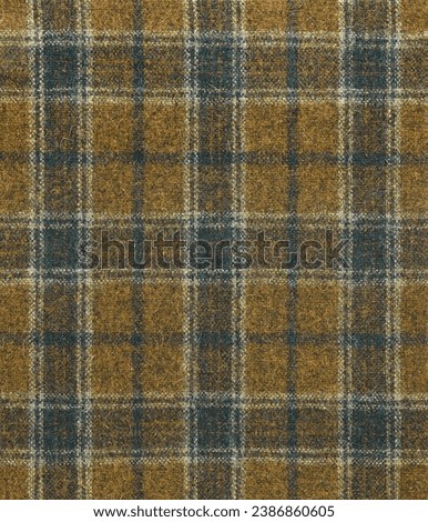 A tartan pattern cloth material in brown and green Royalty-Free Stock Photo #2386860605