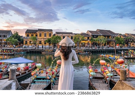 Asian woman wearing vietnam culture traditional at Hoi An ancient town, Vietnam. Hoi An is one of the most popular destinations in Vietnam  from Korea, Thailand, USA, Japan, China Royalty-Free Stock Photo #2386863829