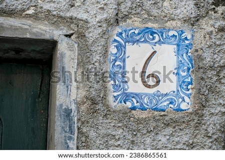 Ceramic number tile on italian old house