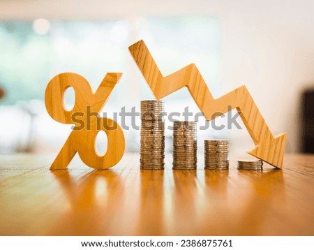 Percentage model and down arrow with coin stack. Key concepts for success, methods, systems of raising or lowering Fed interest rates to correct inflation concepts. Royalty-Free Stock Photo #2386875761