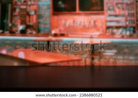 Wooden table on blur of cafe image, coffee shop, bar, background - can used for display or montage your products