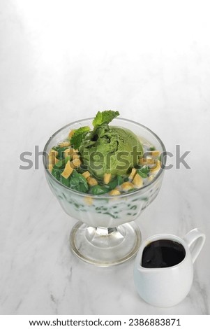 fruit ice with green ice cream topping. isolated in white background