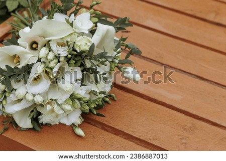 Wedding bouquet of white flowers on a shabby wooden background. Greeting card concept