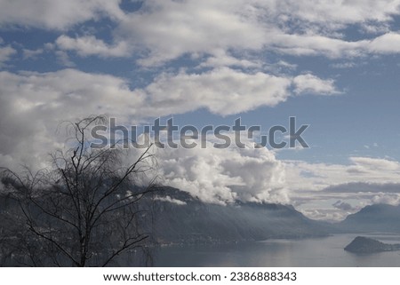 View of a glimpse of lake Como and the promontory of Bellagio on a cloudy day of October. Ligomena area, Lake Como, Italy