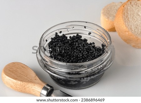 halibut caviar in a glass jar on a white background