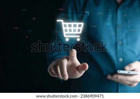 Businessman using mobile and pressing Online shoping icon on virtual screen