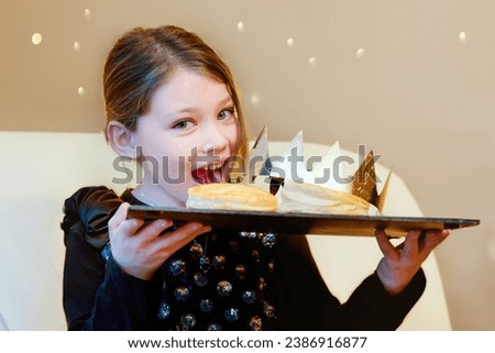 Pretty young girl crowned during Epiphany Royalty-Free Stock Photo #2386916877