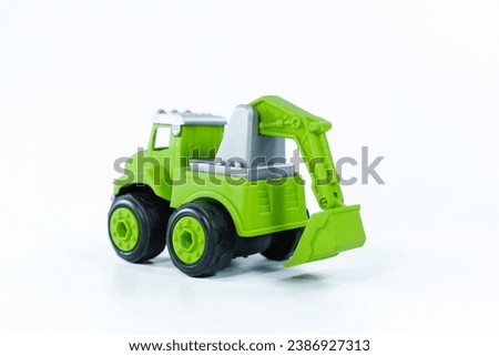 Yellow excavator isolated on white background. Plastic child toy on white backdrop. Construction vehicle. Children's toy. Tractor Toy.