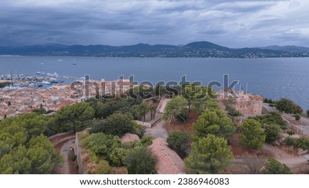 Aerial view of the fort in Saint-Tropez. Photography was shot from a drone at a higher altitude with the bay in the background, on a cloudy day.