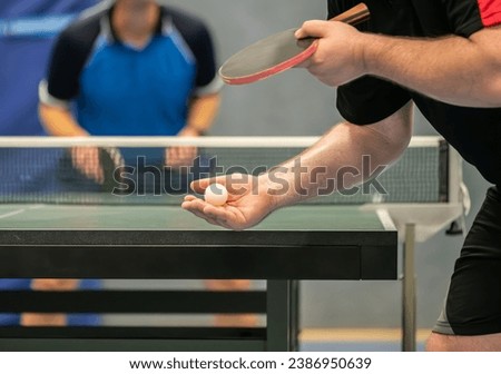 Table tennis player serving in a table tennis championship match Royalty-Free Stock Photo #2386950639