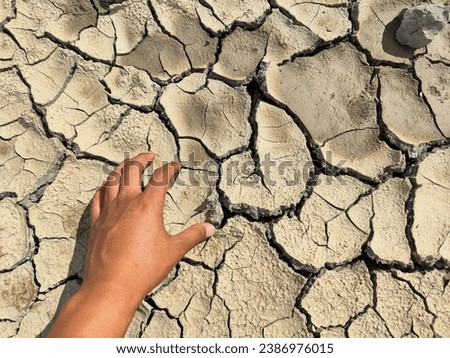 top view cracked red soil ground Earth for texture background,desert cracks,Dry Orange surface Arid,drought land,Picture of natural disaster. drought land Caused by global warming and deforestation.