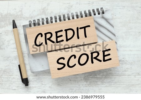 Credit score wooden blocks with text on a gray notepad