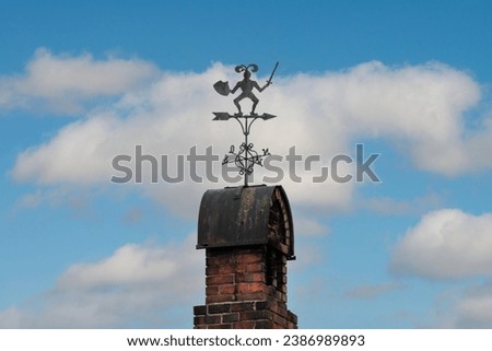weather vane against a blue sky Royalty-Free Stock Photo #2386989893
