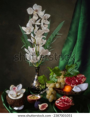 Still life with branch of orchid and exotic fruits