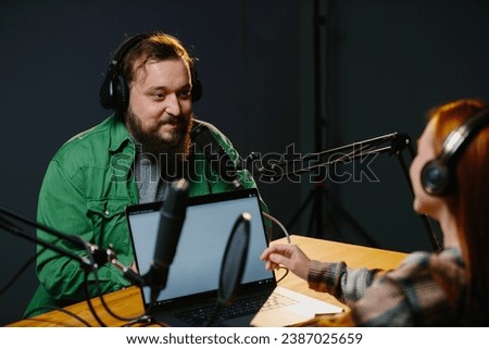 Radio presenters communicate live. The presenter and his guest have a conversation during the broadcast.