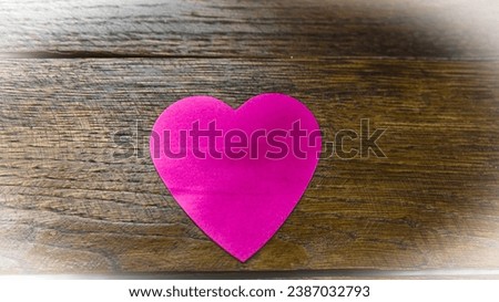 Heart shaped paper cut out on table, love message and Valentine`s day concept.