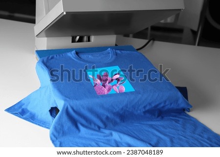 Custom t-shirt. Using heat press to print image of violet cactus