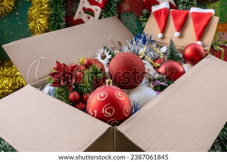 Open cartoon box with Christmas balls and other decorations 