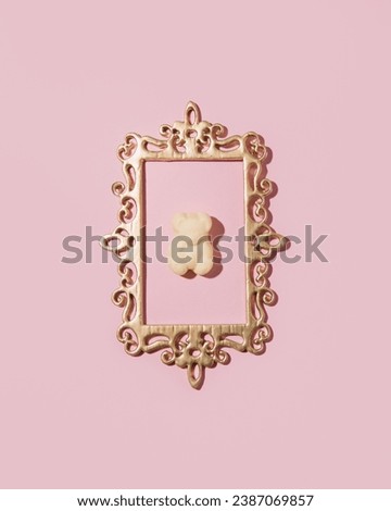Gummy bear, candy in picture frame, creative pastel pink layout.