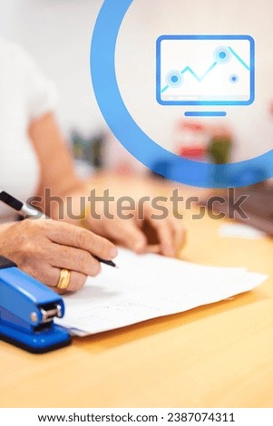 Latina woman, director of a bank, wearing a white blouse, working in her office. On her desk, there are documents, and she is writing with a pen in her hand. Additionally, a blue-colored statistical 
