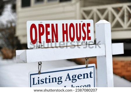 Open House notification on a For Sale sign in front of home house.