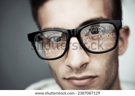 Portrait, glasses and formula with a man programmer closeup in studio on a gray background for support. Face, eyewear and software development with a young nerd or geek reading coding data or info