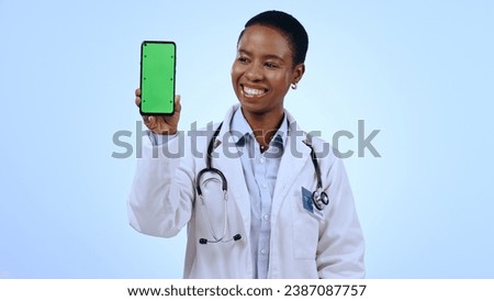Green screen, black woman and doctor with a cellphone, healthcare or professional on blue background. African person, medical or physician with smartphone, tracking markers or promotion with medicare