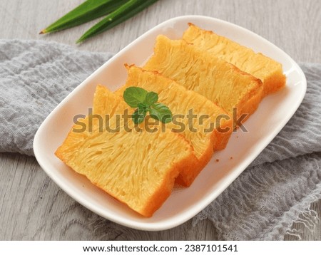 Kue bika Ambon or kuih bingka Ambon or kueh bengka Ambon is cake from Medan, Indonesia. Its made with tapioca starch, egg and coconut milk with honeycomb texture. served on plate. selected focus Royalty-Free Stock Photo #2387101541