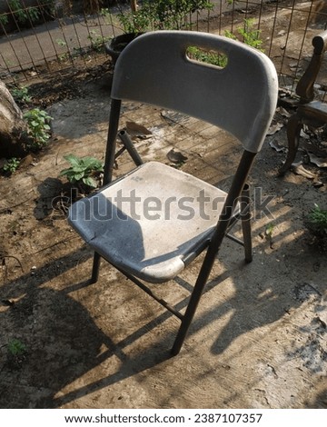 chair silver black metal street sun Royalty-Free Stock Photo #2387107357
