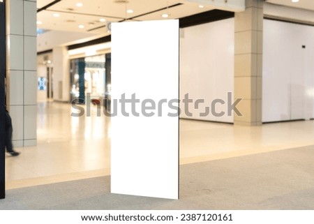 White Vertical sign sitting in the middle of a mall, perfect for any mockup or design.