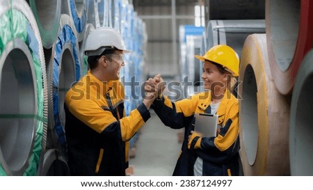 Workers chatting and laughing in a factory.