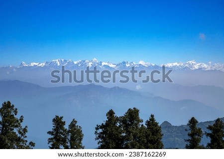 snow capped Saklana range in Dhanaulti tehsil of Tehri Garhwal district in Uttarakhand, India.  Royalty-Free Stock Photo #2387162269